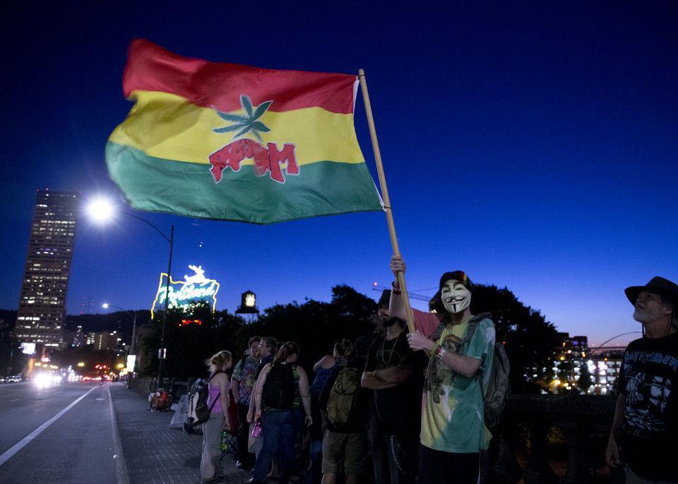A large gathering was held at the Burnside Bridge Tuesday night as recreational marijuana became legal at midnight, July 1, 2015, in Oregon. Beth Nakamura/ Oregonian Staff
